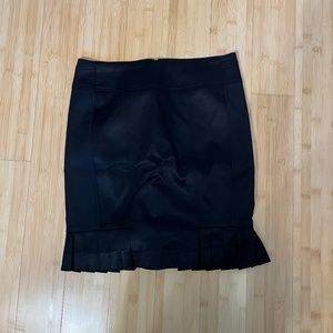 Black bebe skirt with pleated detail.